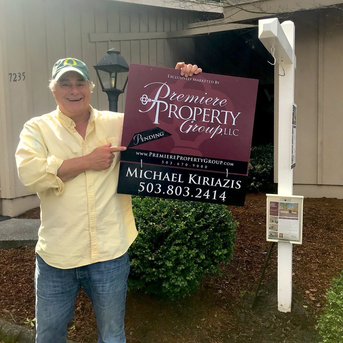 Michael Kiriazis at the yard sign of a home he sold in the Portland metro.