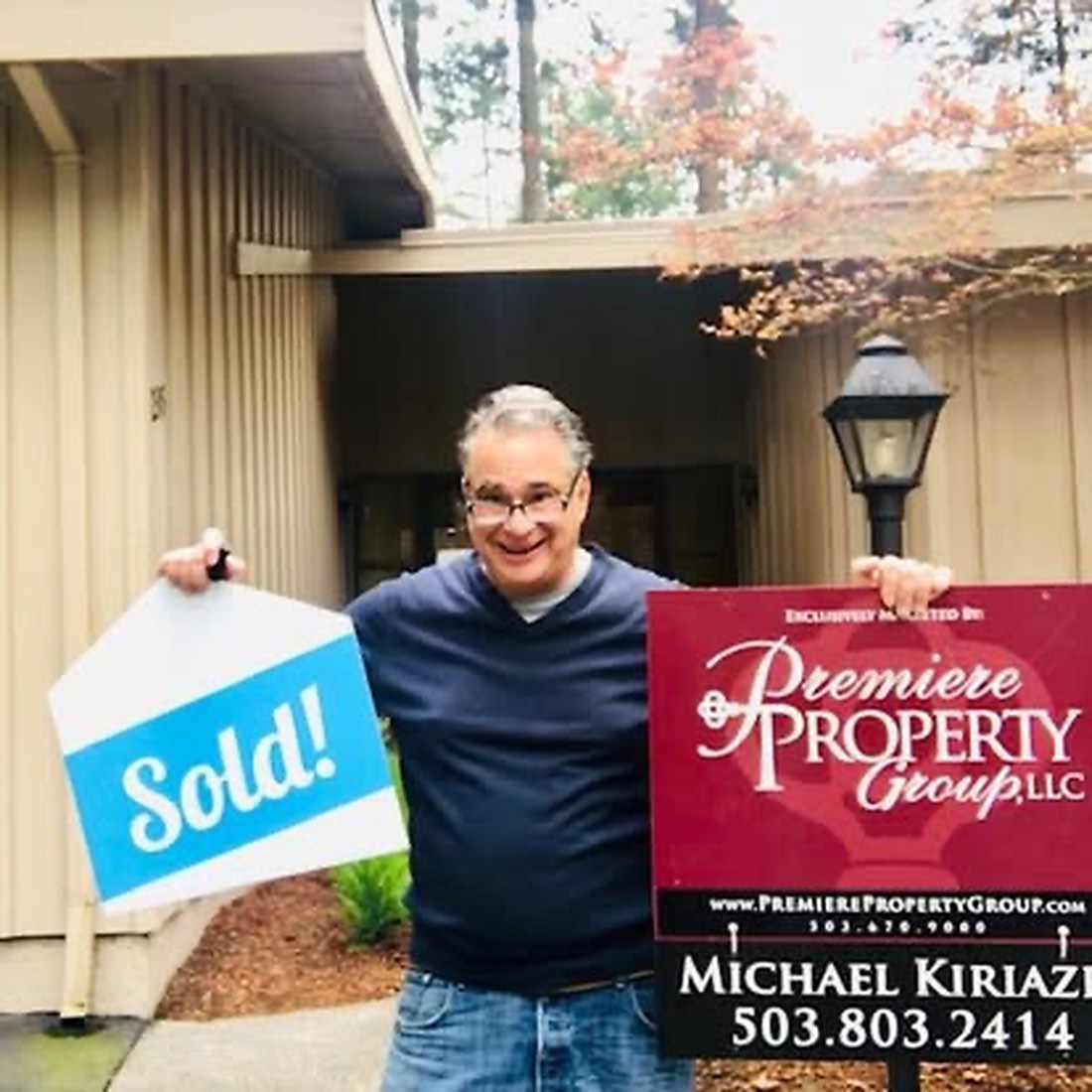 Michael Kiriazis with a Sold sign at a Portland home he sold